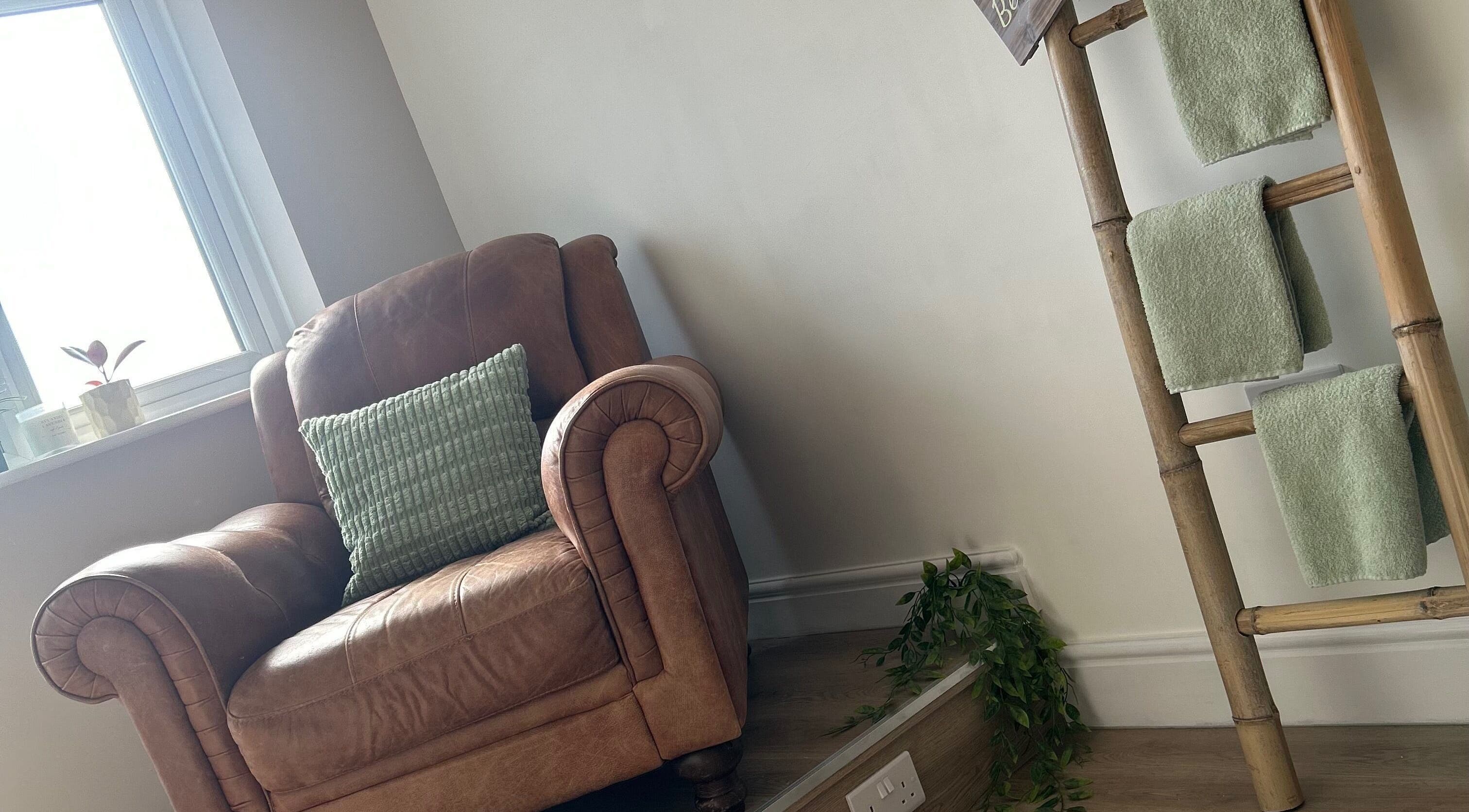 Cozy brown leather chair and bamboo towel rack at Sophie’s Ultimate Beauty, Deeping Saint James, England, GB.