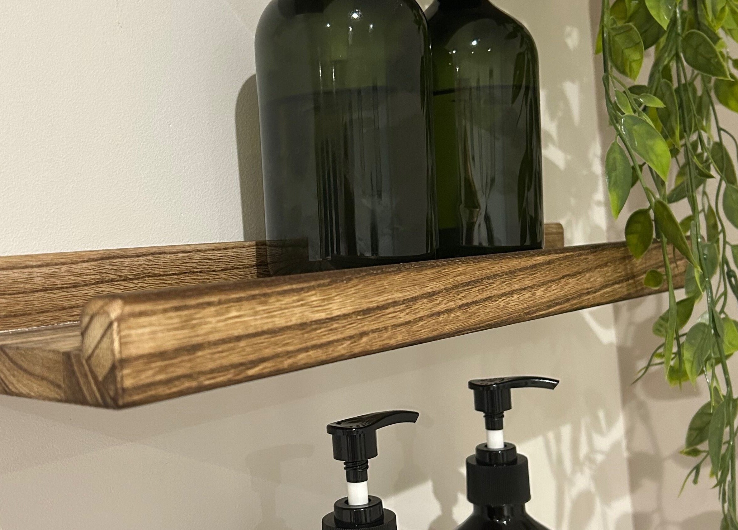 Stylish shelf with bottles at Sophie's Ultimate Beauty, Deeping Saint James, England, GB.