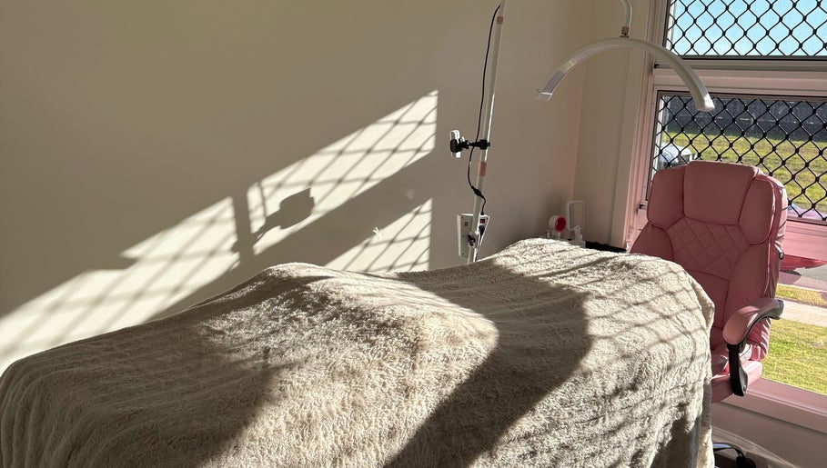 Sunlit treatment room at JH Beauty in Upper Caboolture, Queensland, AU, featuring a plush chair and cozy blanket.