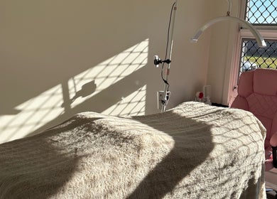 Sunlit treatment room at JH Beauty in Upper Caboolture, Queensland, AU, featuring a plush chair and cozy blanket.