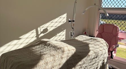 Sunlit treatment room at JH Beauty in Upper Caboolture, Queensland, AU, featuring a plush chair and cozy blanket.