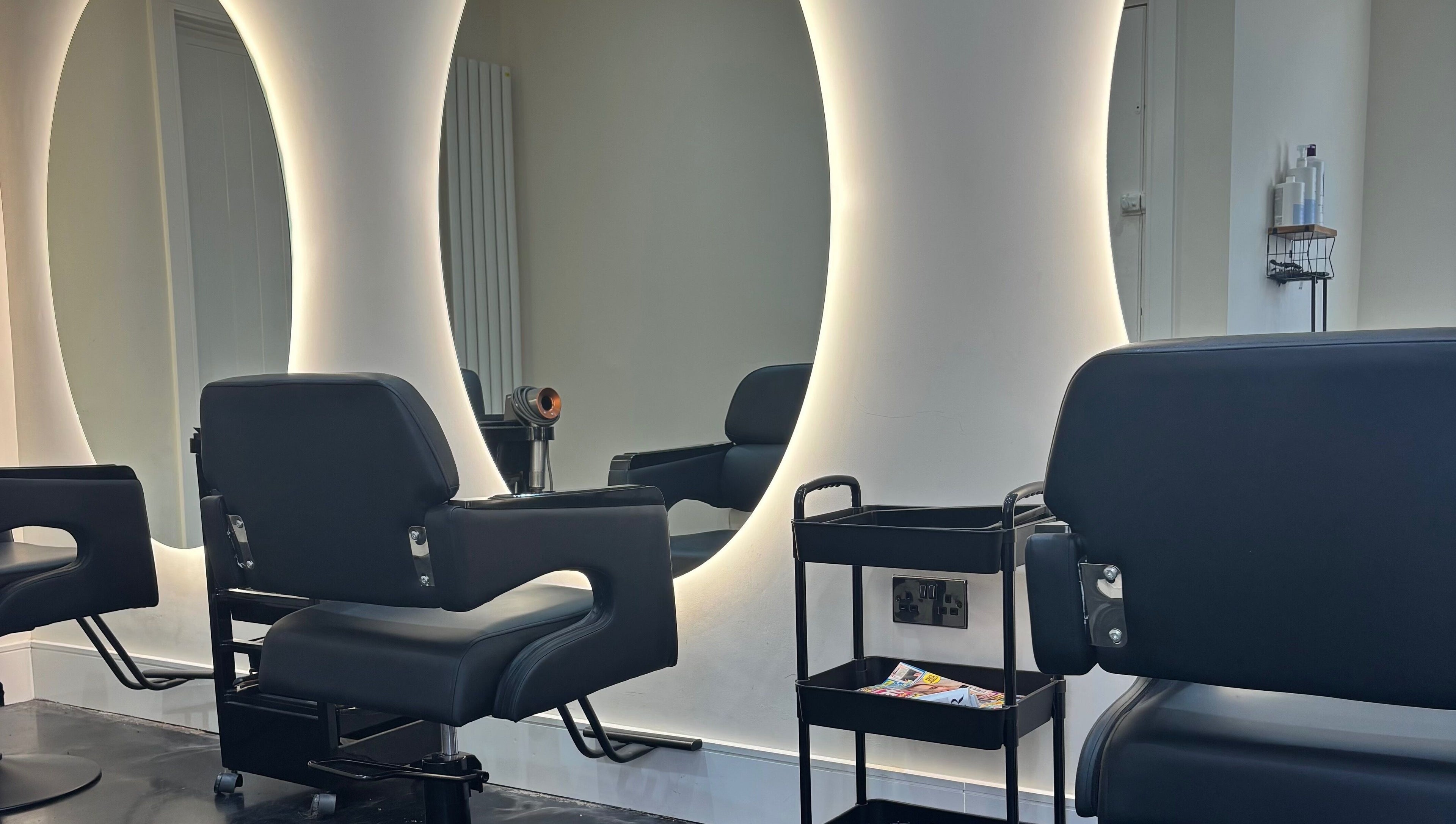 Stylish salon chairs and illuminated mirrors at Hair by Shannon Summers, Leicester, England, GB.