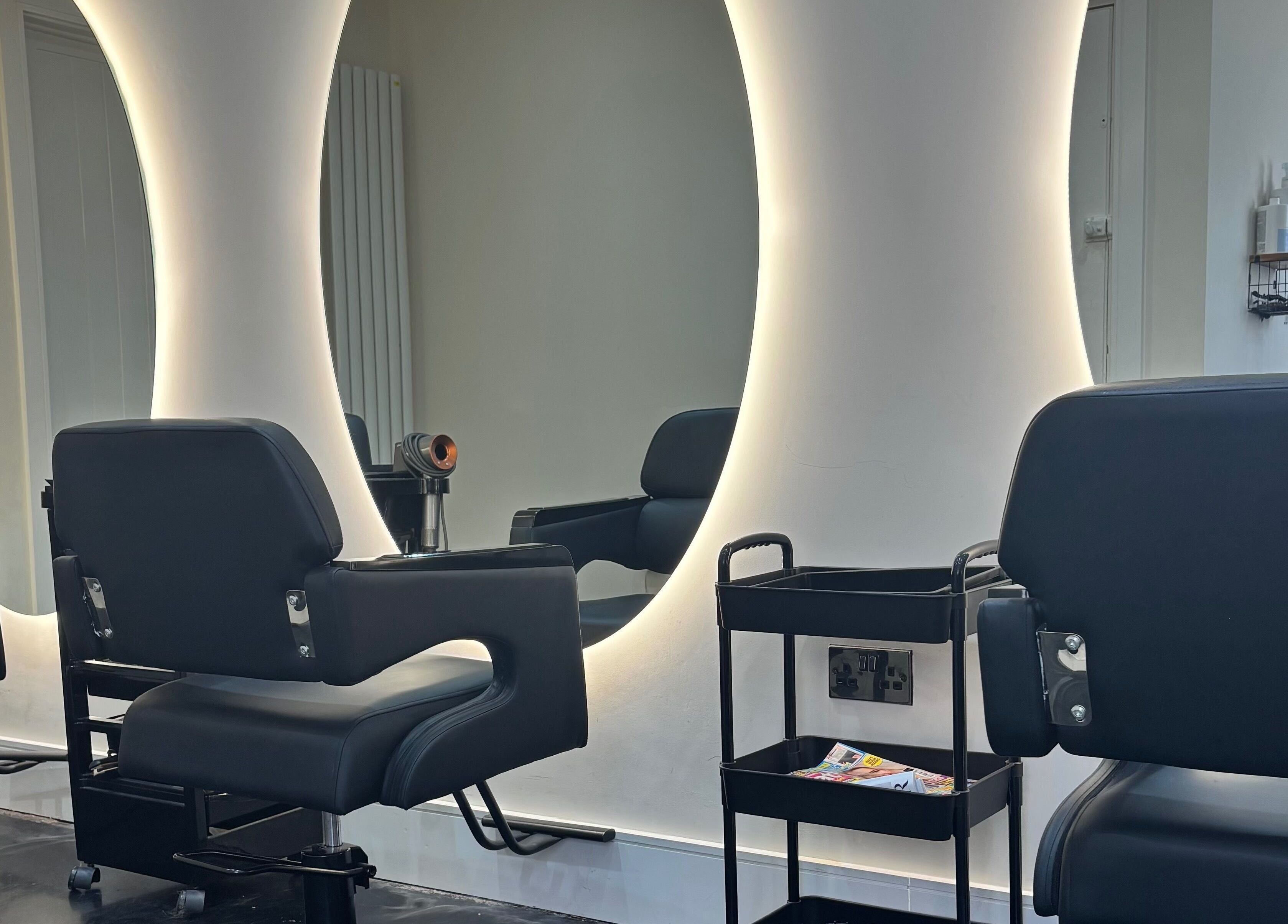 Stylish salon chairs and illuminated mirrors at Hair by Shannon Summers, Leicester, England, GB.