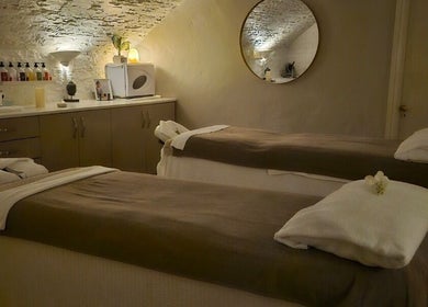 Tranquil treatment room at Peterstone Court Country House & Spa, Llanhamlach, Wales, GB with massage tables.