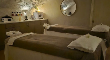Tranquil treatment room at Peterstone Court Country House & Spa, Llanhamlach, Wales, GB with massage tables.