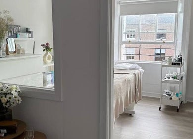 Tranquil treatment room at Nonna Skincare, Dublin, County Dublin, IE, featuring elegant decor and a cozy bed.