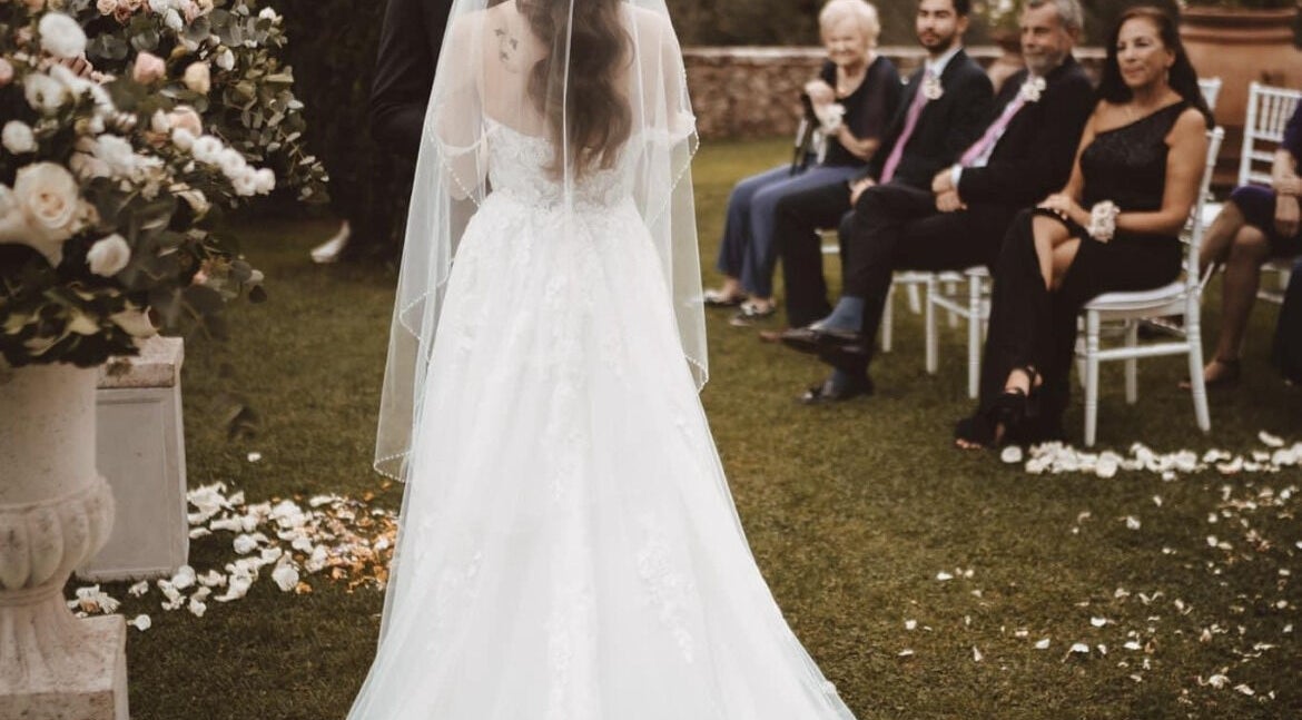 Bridal ceremony at Divine Beauty Parlor in San Antonio, Texas, US, with guests seated on lawn.