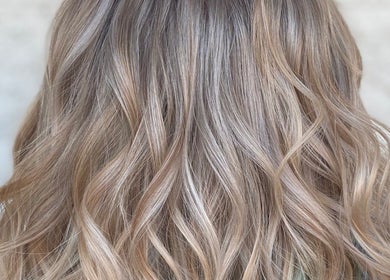 Wavy, blonde hair styled at Divine Beauty Parlor in San Antonio, Texas, US.