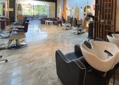 Modern interior of The Comb Salon in Cairo Governorate, Cairo Governorate, EG with sleek styling chairs.
