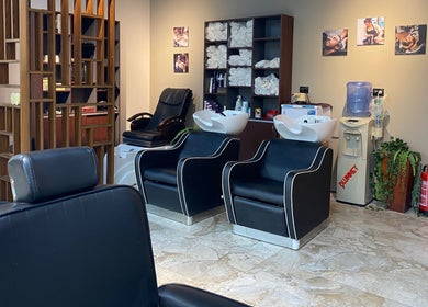 Modern salon setup at The Comb Salon, Cairo Governorate, EG with chairs and stylish decor.