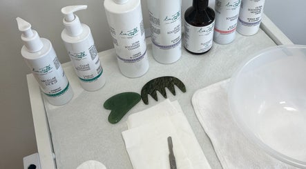 Niche Beauty by Lisa skincare products and tools on a white table in Rochester, England, GB.