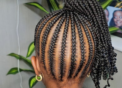 Intricate braids styled at Royalils Braids, Laurel, Maryland, US. High ponytail with detailed plaiting.