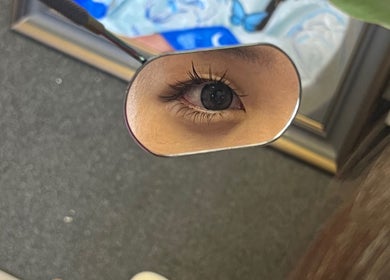 Close-up of eye reflecting in a mirror at Killer Rose Lash, Arlington, Virginia, US.