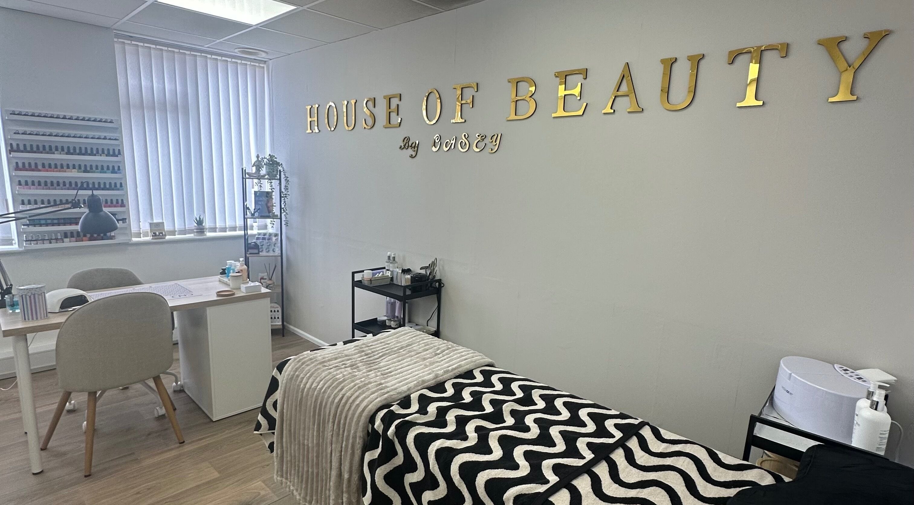 Interior of House Of Beauty By Casey Thomas in Castleford, England, GB showing stylish salon setup with nail polish display.