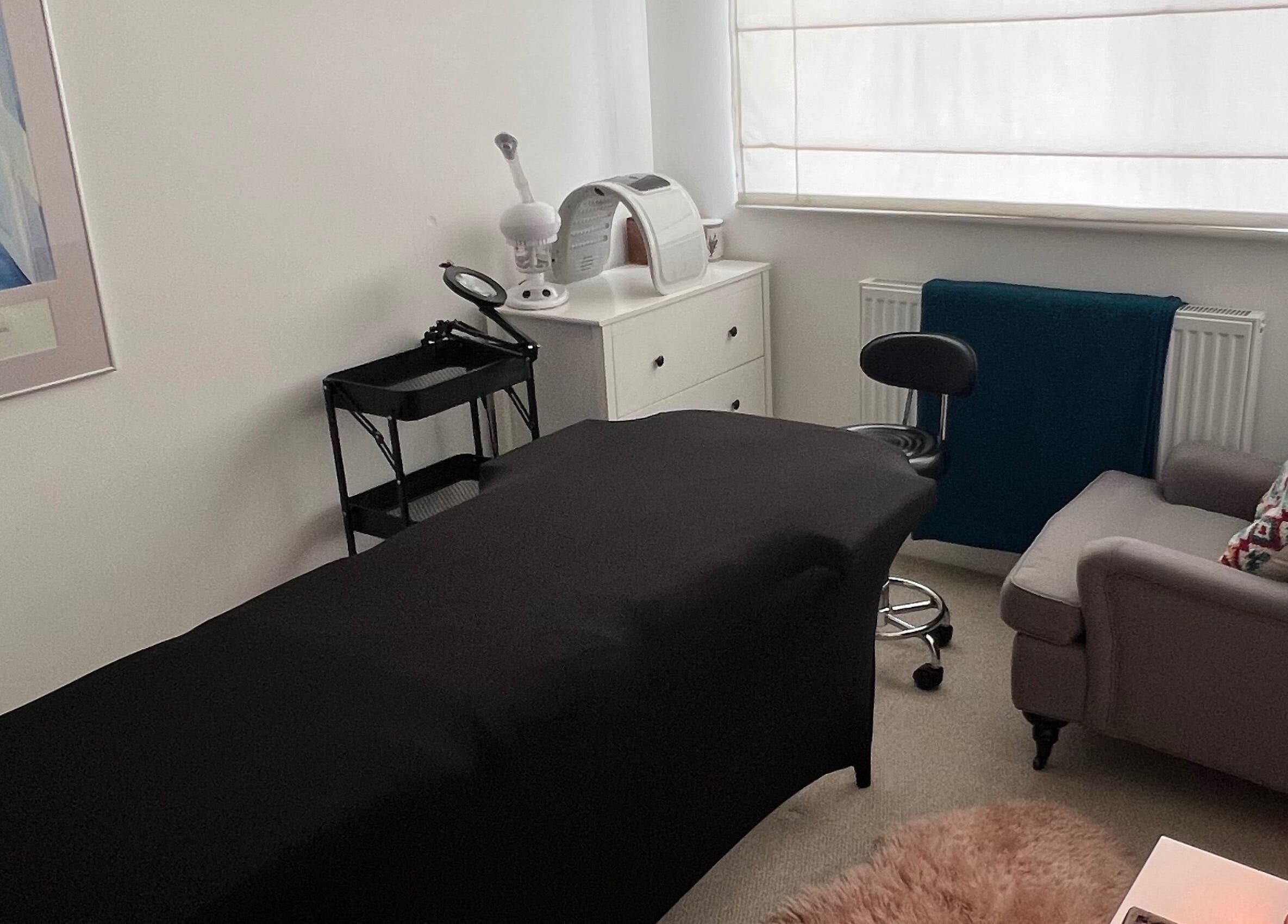 Cozy treatment room at Face Spa in Hastings, England, GB featuring a massage table and relaxing decor.