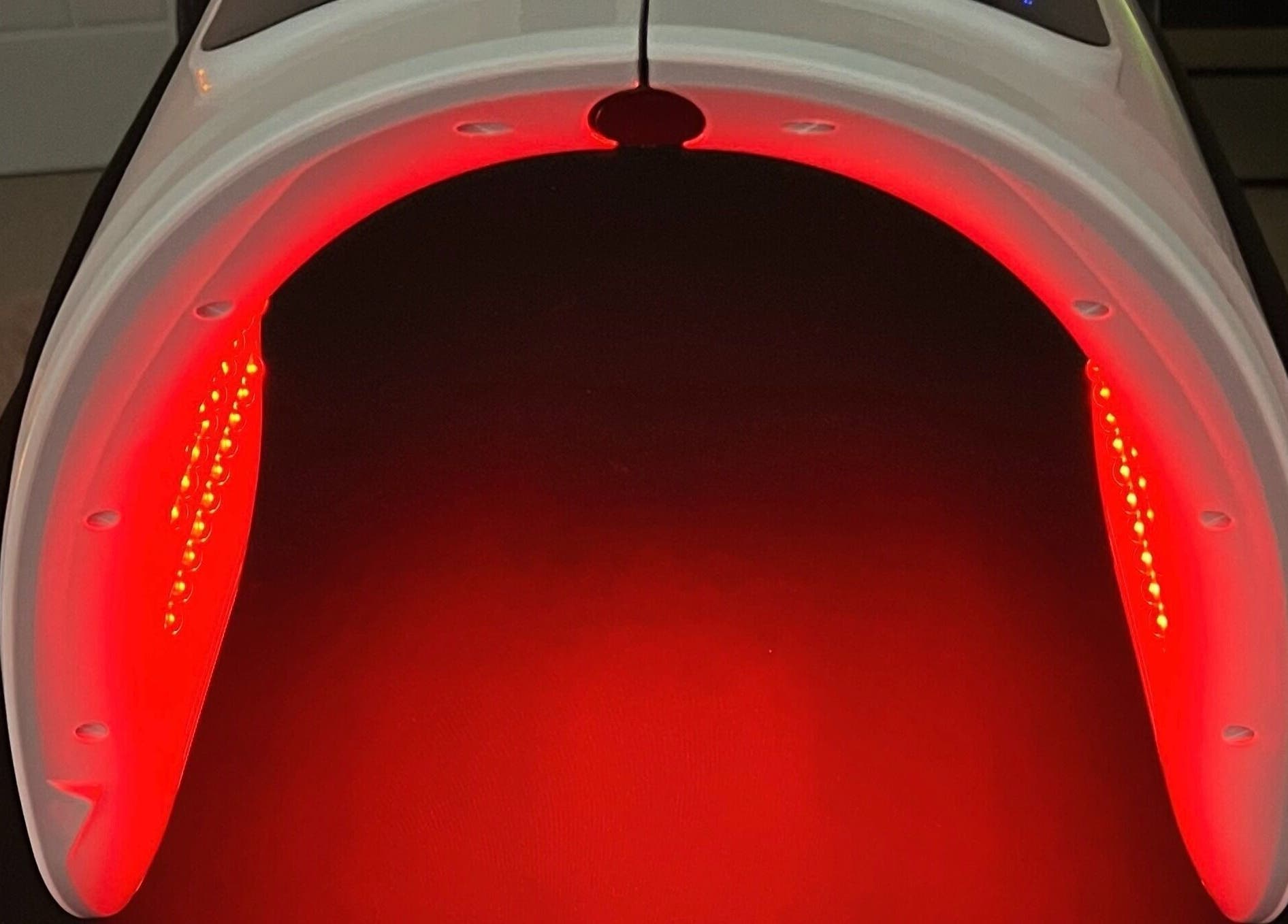 Red LED light therapy device at Face Spa, Hastings, England, GB, enhancing skin rejuvenation.