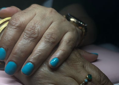 Close-up of turquoise manicured nails with gold bracelets at Klaw Cartel, Birmingham, England, GB.