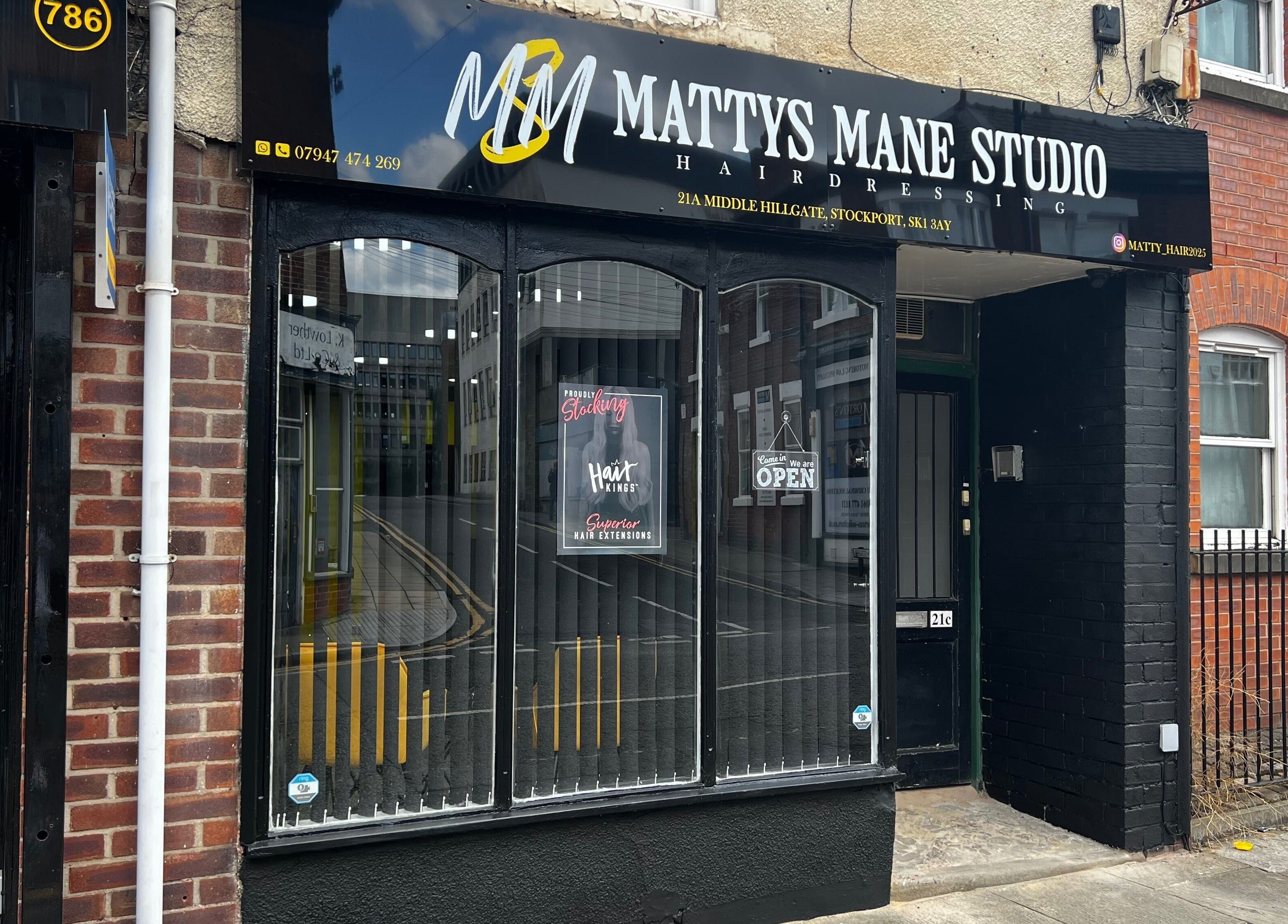 Exterior view of MMS Mattys Mane Studio, Stockport, England, GB. Beautiful salon entrance on a quaint street.