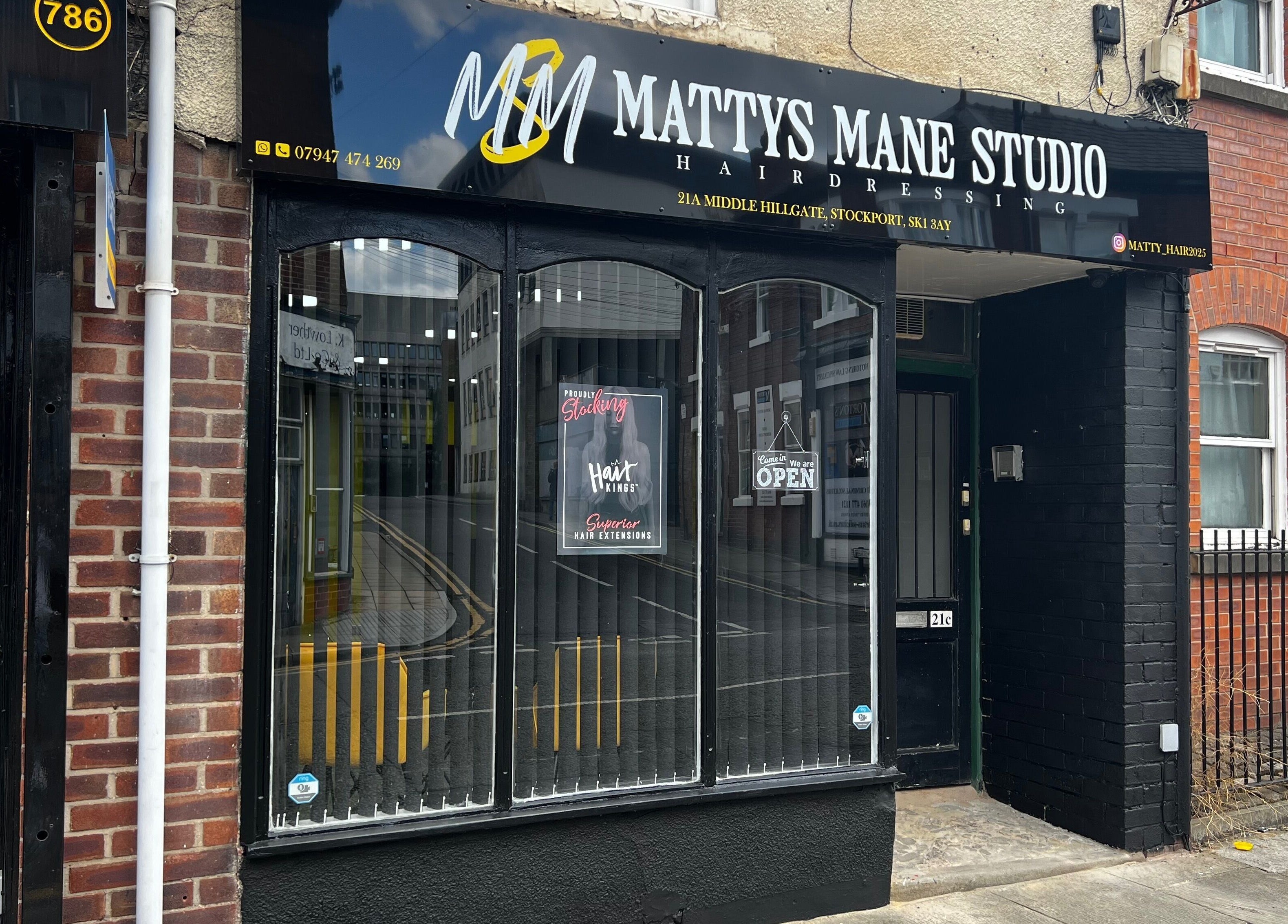 Exterior view of MMS Mattys Mane Studio, Stockport, England, GB. Beautiful salon entrance on a quaint street.