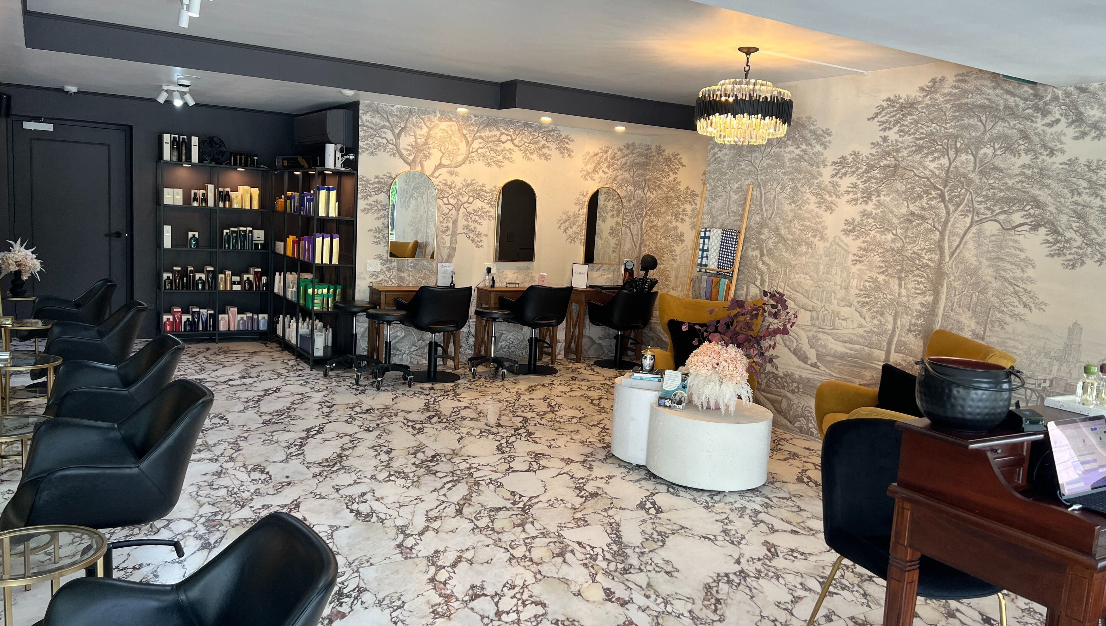 Chic interior of Kaitlyn Wagner Hairdressing in Hawthorne, Queensland, AU, featuring elegant decor and styling stations.
