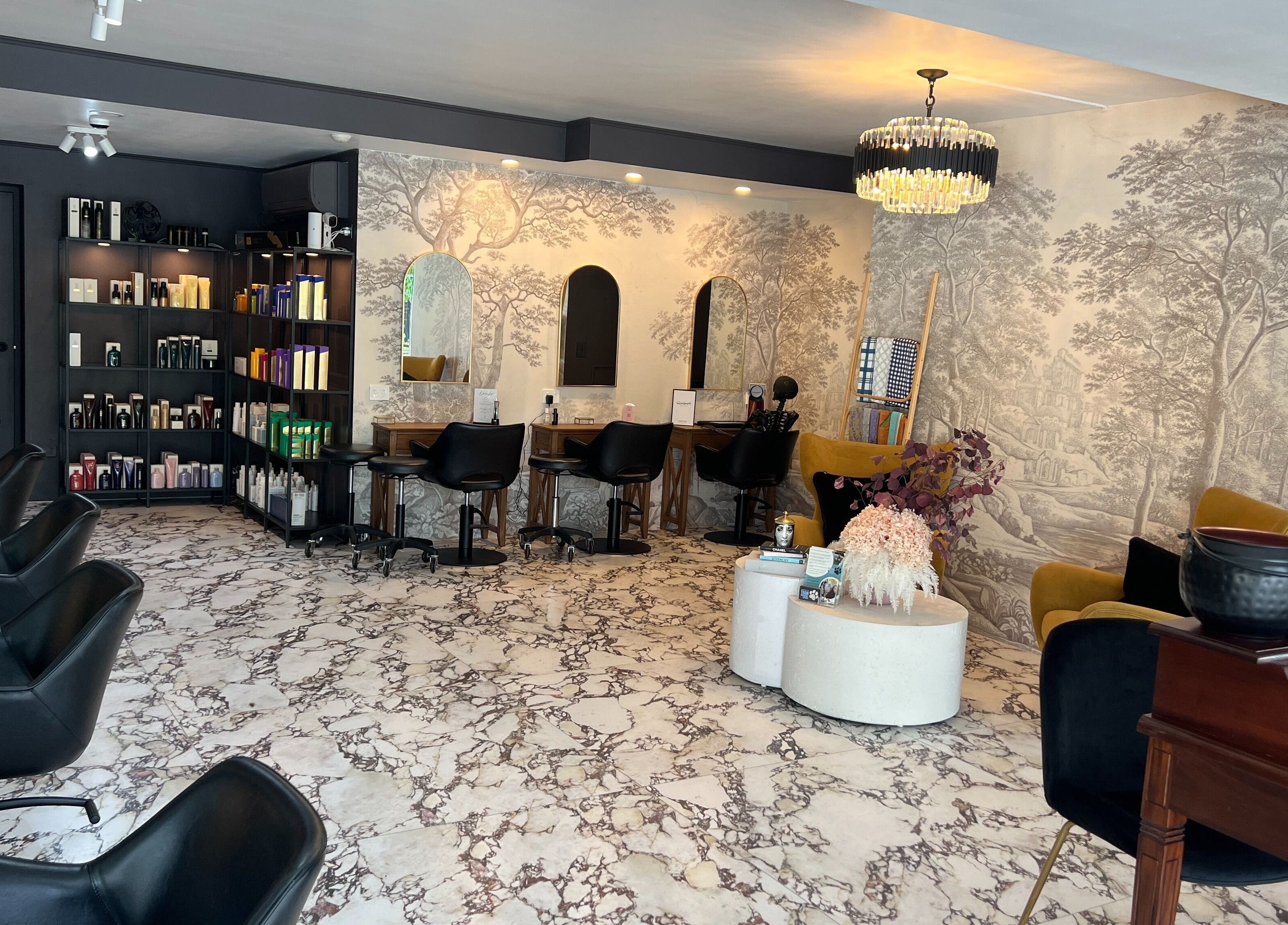 Chic interior of Kaitlyn Wagner Hairdressing in Hawthorne, Queensland, AU, featuring elegant decor and styling stations.