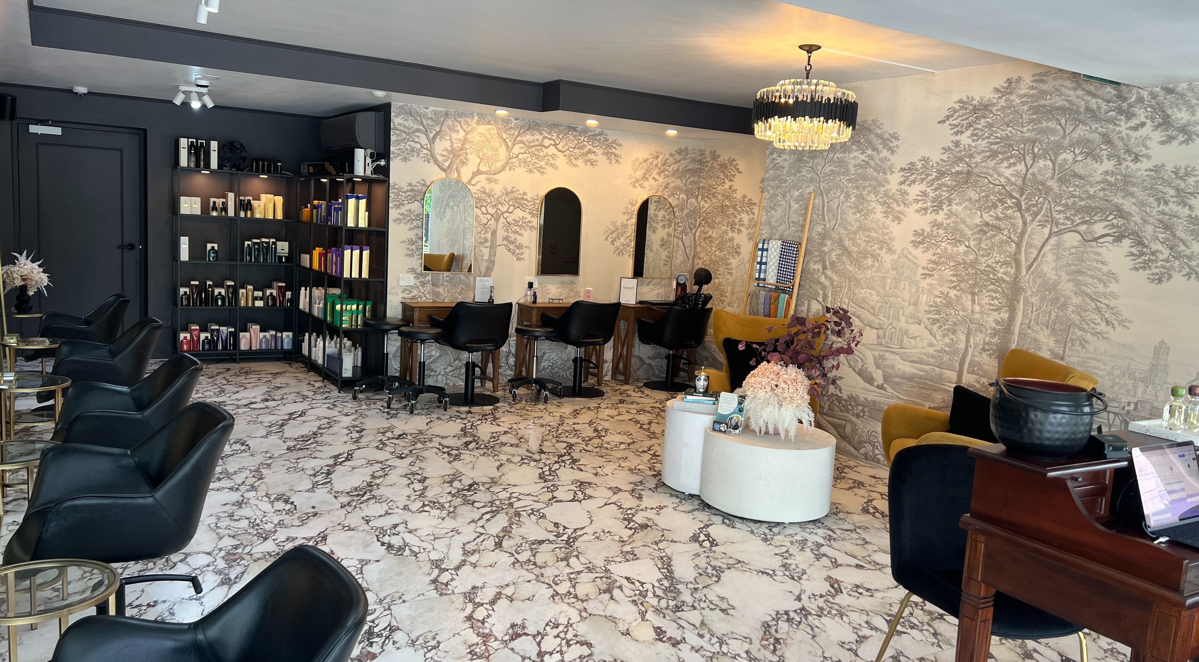 Chic interior of Kaitlyn Wagner Hairdressing in Hawthorne, Queensland, AU, featuring elegant decor and styling stations.