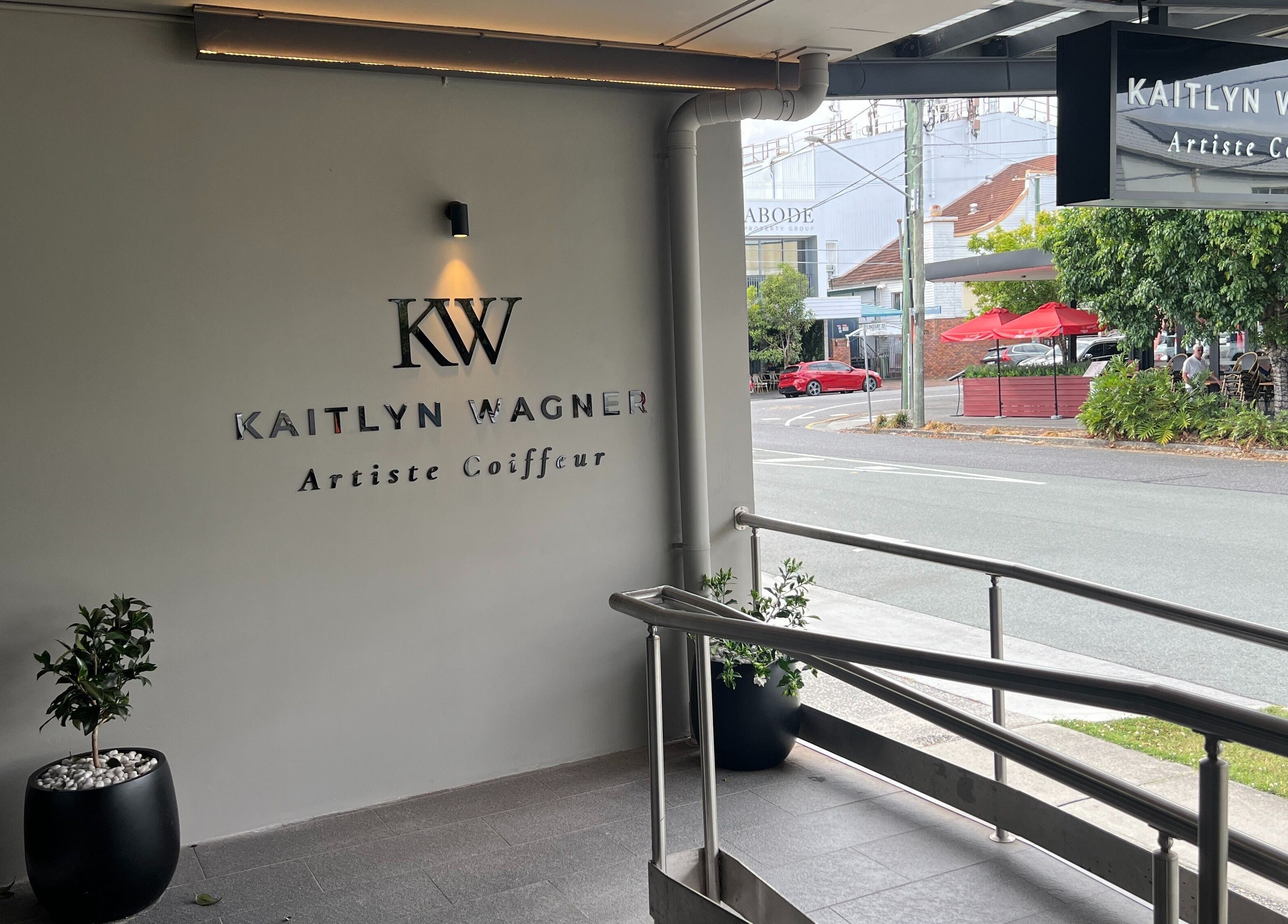 Elegant entrance of Kaitlyn Wagner Hairdressing in Hawthorne, Queensland, AU, showcasing modern design.