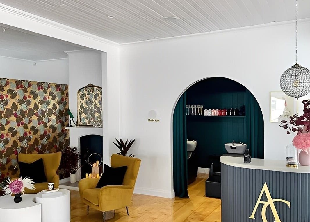 Elegant interior of Kaitlyn Wagner Hairdressing in Hawthorne, Queensland, AU, featuring vintage decor and styling chairs.