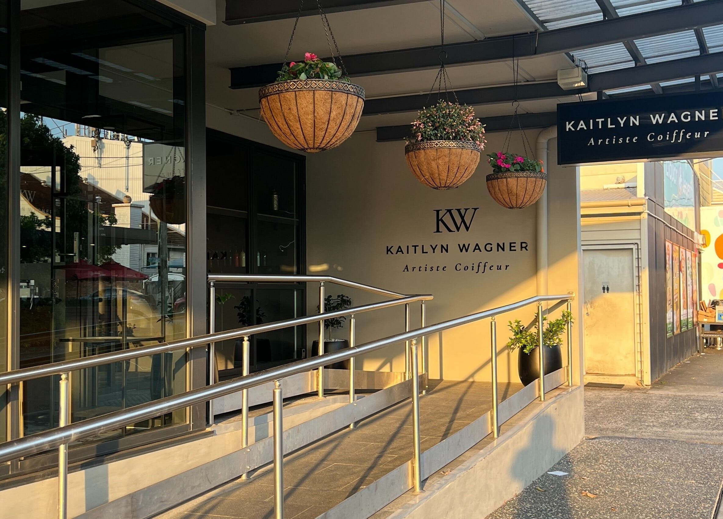 Entrance of Kaitlyn Wagner Hairdressing in Hawthorne, Queensland, AU with hanging plants and signage.