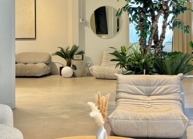 Relaxing lounge area at SC Beauty - DTLA, Los Angeles, California, US featuring lush plants and cozy seating.