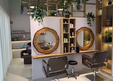 Chic salon interior with wooden mirrors and styling chairs at Lavender Moon Ladies Salon, Dubai, AE.