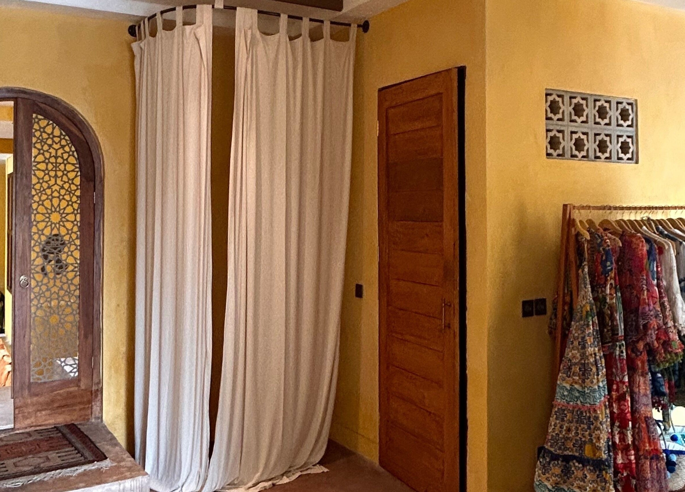 Entrance with ornate wooden door and colorful gowns at Limu Spa Moroccan, Bali, Bali, ID.