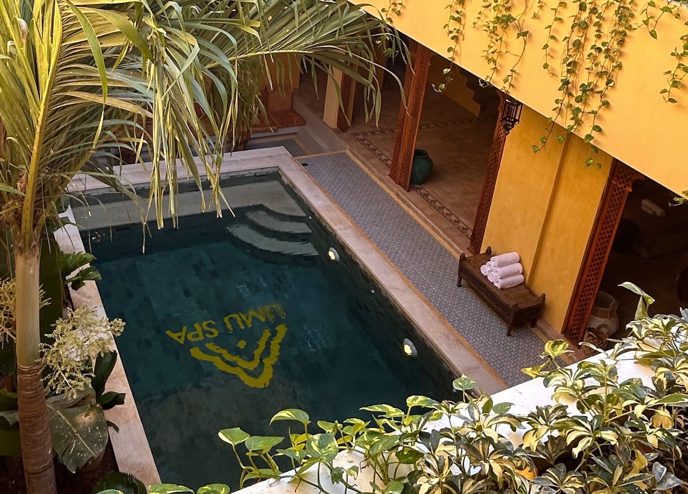 Tranquil poolside at Limu Spa Moroccan, Bali, Bali, ID with lush greenery and elegant architecture.