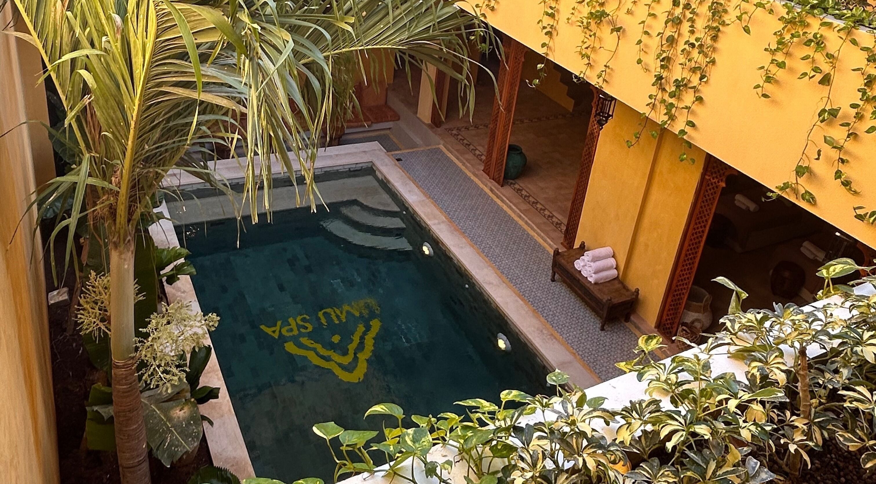 Tranquil poolside at Limu Spa Moroccan, Bali, Bali, ID with lush greenery and elegant architecture.