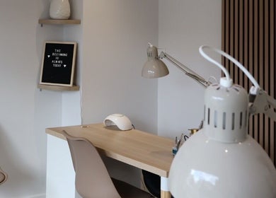 Modern nail station at Pure Beauty, Holytown, Scotland, GB with sleek decor and warm lighting.