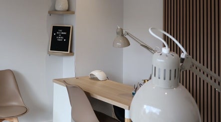 Modern nail station at Pure Beauty, Holytown, Scotland, GB with sleek decor and warm lighting.