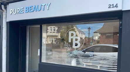 Exterior view of Pure Beauty, Holytown, Scotland, GB, showcasing its stylish signage and welcoming entrance.