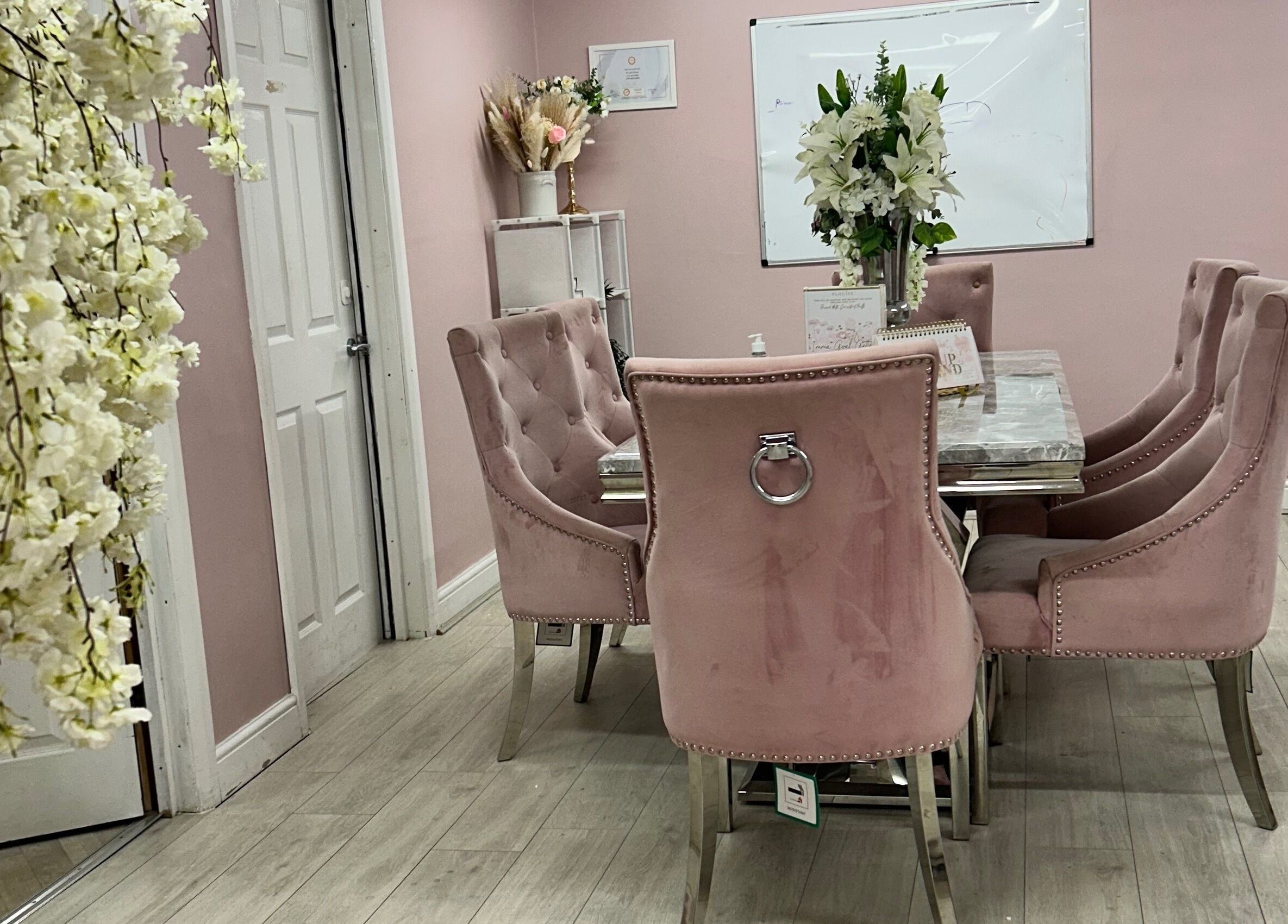 Luxurious pink meeting room at Rhilaxandrhivive, Barnsley, England, GB, featuring stylish seating and floral decor.
