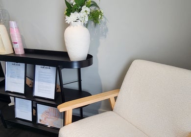 Elegant waiting area at Nail Nook in Cooranbong, New South Wales, AU with a cozy chair and floral decor.
