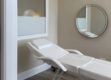 Relaxing treatment room at Sorelle Beauty House, Lytham St Annes, England, GB with a stylish white recliner.