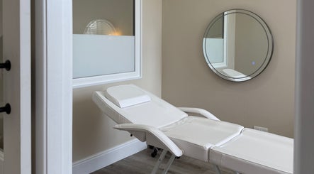 Relaxing treatment room at Sorelle Beauty House, Lytham St Annes, England, GB with a stylish white recliner.