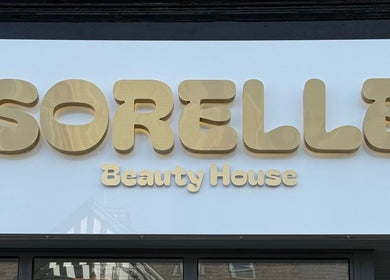 Elegant gold signage of Sorelle Beauty House in Lytham St Annes, England, GB.