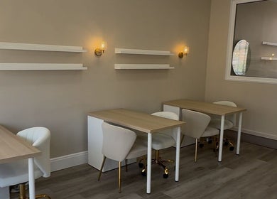 Elegant interior at Sorelle Beauty House, Lytham St Annes, England, showcasing modern tables and chairs.