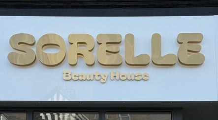 Sorelle Beauty House storefront sign in Lytham St Annes, England, GB with elegant gold lettering.