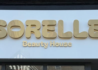 Sorelle Beauty House sign with elegant gold lettering in Lytham St Annes, England, GB.