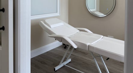 Elegant spa room with a white treatment bed at Sorelle Beauty House, Lytham St Annes, England, GB.