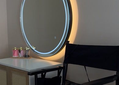 Elegant vanity at Sorelle Beauty House, Lytham St Annes, England, GB with round mirror and chic chair.