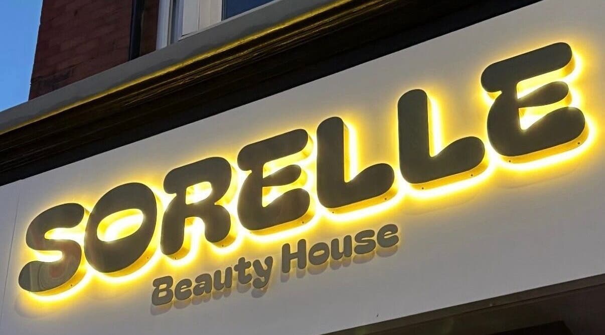 Illuminated Sorelle Beauty House sign in Lytham St Annes, England, GB, showcasing elegance and style.