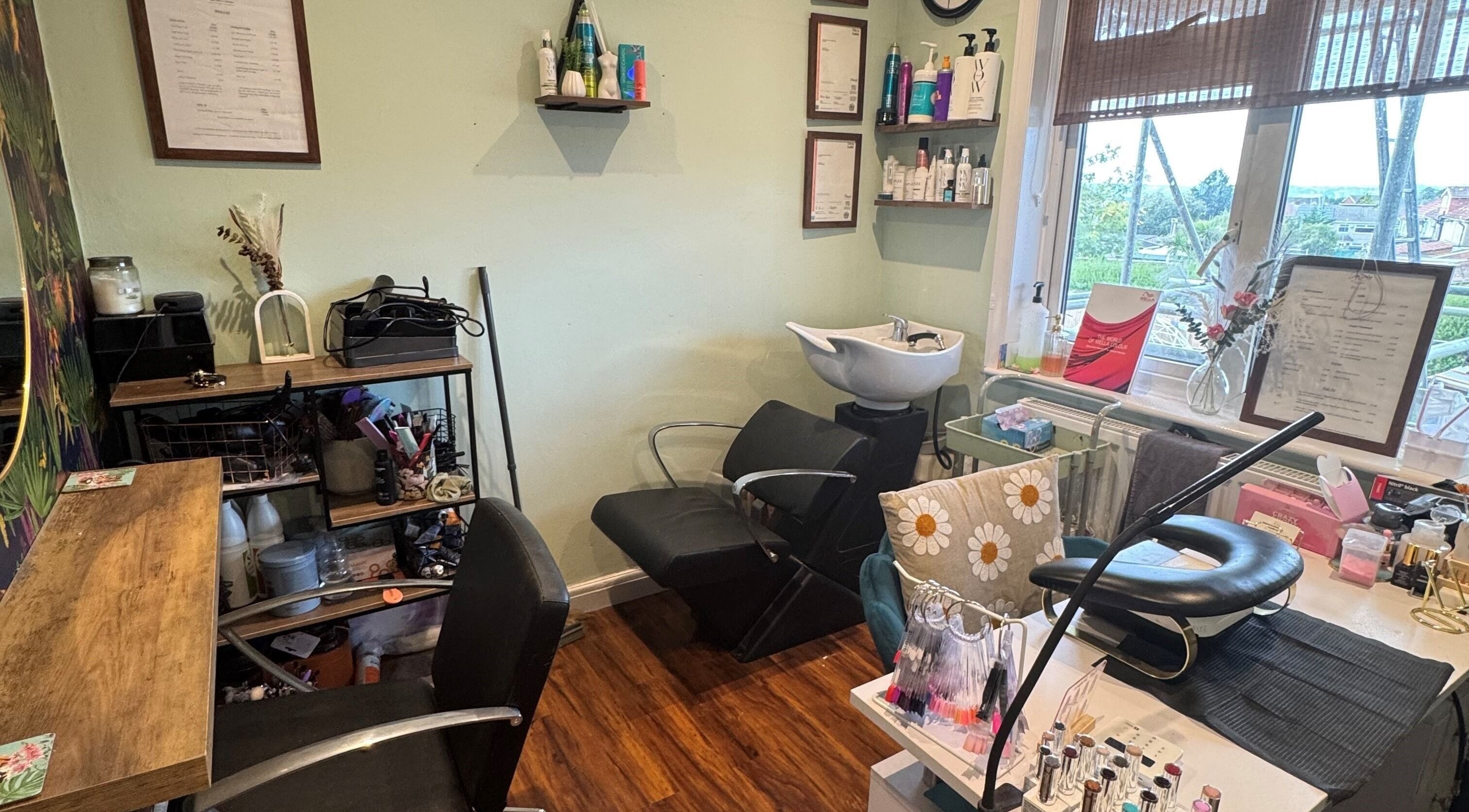 Cozy interior of Jodie Sweeting Beauty, Bristol, England, GB with salon chairs and beauty products.