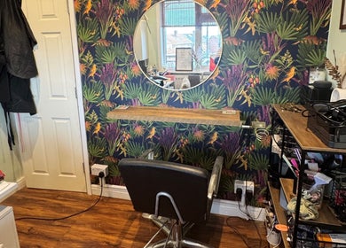 Chic salon station at Jodie Sweeting Beauty, Bristol, England, GB with vibrant wallpaper and modern decor.